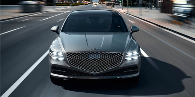 A sleek luxury sedan running on highway.