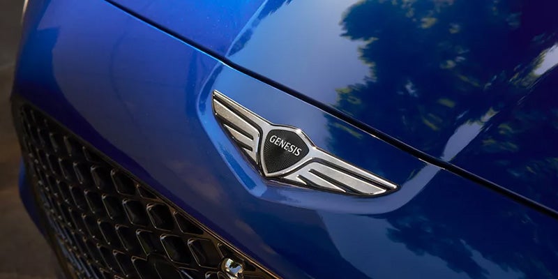 Front view and logo of Genesis G70 vehicle is displayed here.