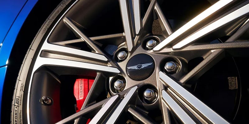 Close-up of a car wheel showing the alloy rim design and brake caliper.