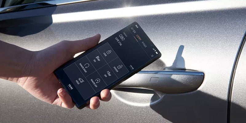 Smartphone controlling car lock features near a vehicle door handle